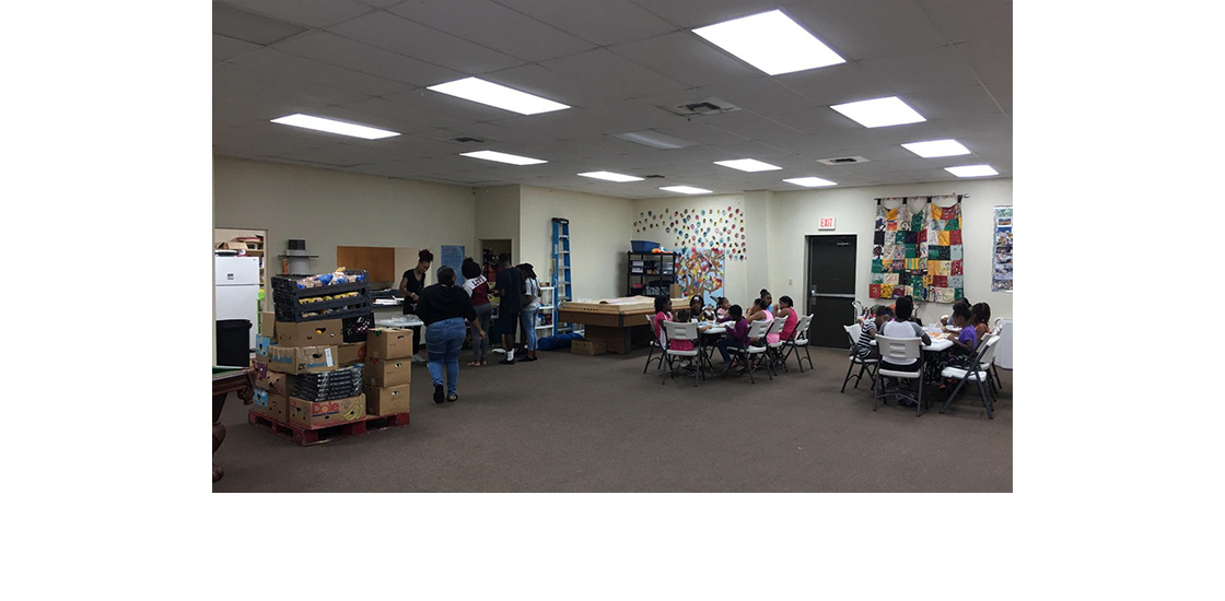 Volunteer serving prepared food to children at Elleanor Johnson Youth Center in Fort Walton Beach